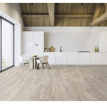 Ljust, rymligt kök med takbjälkar i trä, matbord och pentry