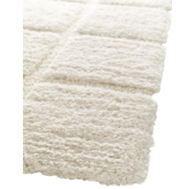 Detaljbild av en ljus, rektangulär matta