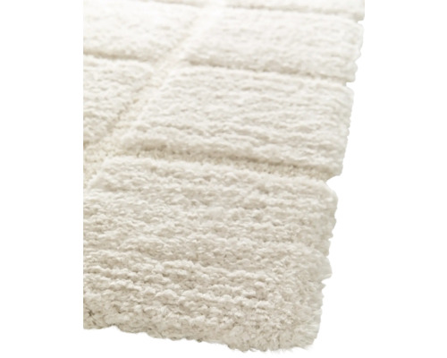 Detaljbild av en ljus, rektangulär matta