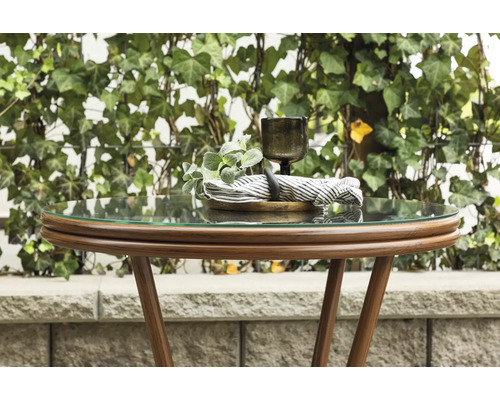 Runt sidobord med glasskiva och dekoration