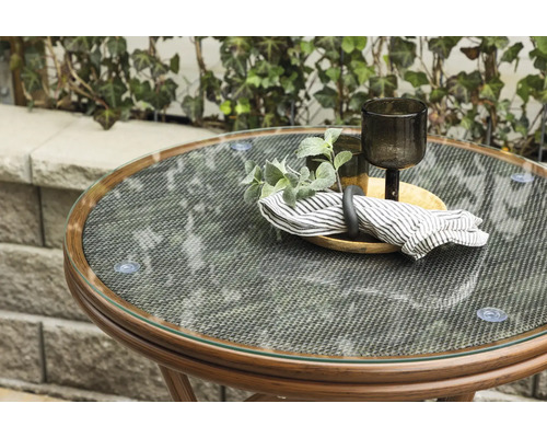 Runt bord med glasskiva och dekoration