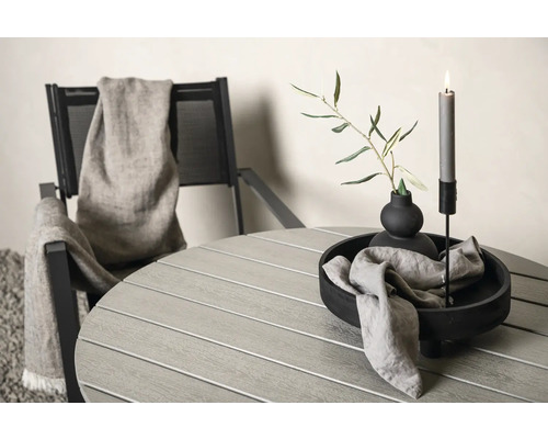 Trädgårdsscen med runt bord, stol och dekorationer som ljus och växter