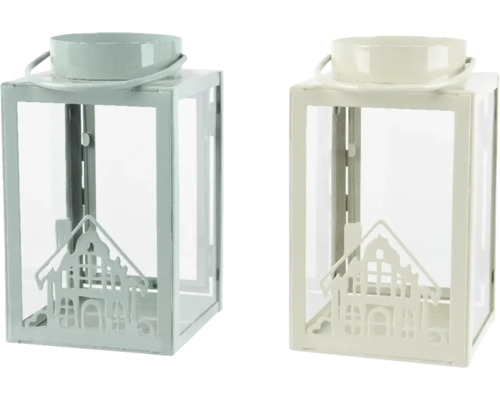 Två dekorativa lyktor i metall med husmotiv och glasinsatser