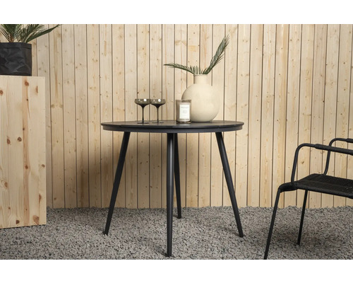 Runt matbord med tre ben, med dekoration på den