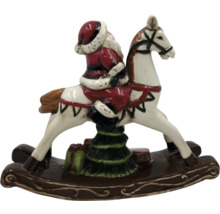 Juldekoration: Jultomten på en gunghäst med julgran och presenter.