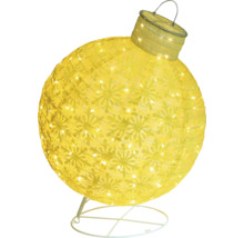 Gul julgranskula med snöflingamönster och belysning på ett stativ