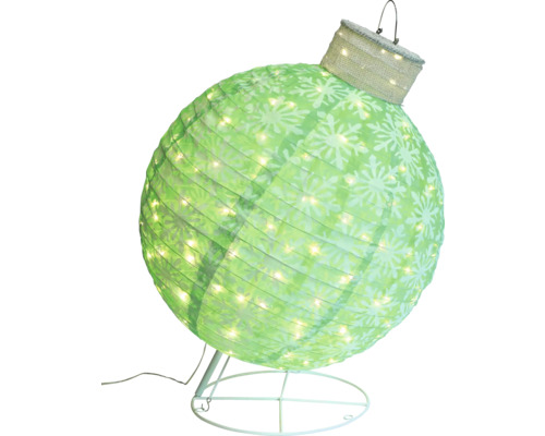 Dekorativ, upplyst julkula med snöflingamönster på ett stativ