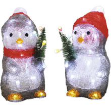 Två dekorativa pingviner med mössa och julgran