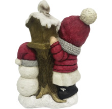 Dekorativ juldekoration med snögubbe och barn vid en lykta