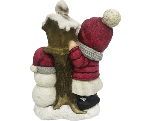 Dekorativ juldekoration med snögubbe och barn vid en lykta