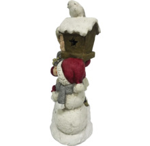 Dekorativ snögubbe med fågelholk och fågel