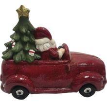 Juldekoration: Jultomten kör bil med julgran