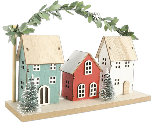 Dekoration med tre hus, träd och bladgirlang