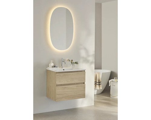 Badrumsscen med tvättställsskåp, tvättställ, spegel med belysning och badkar