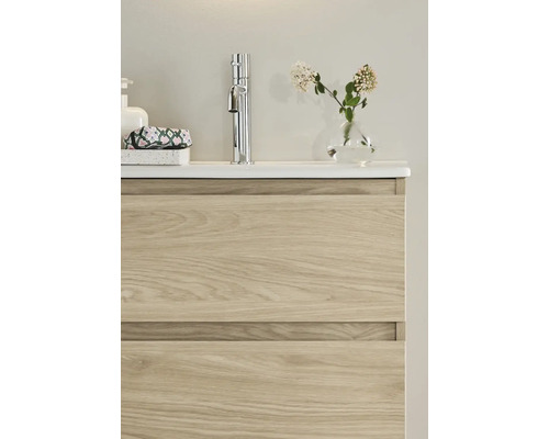 Tvättställsskåp med två lådor, armatur, tvålpump och dekoration på tvättstället