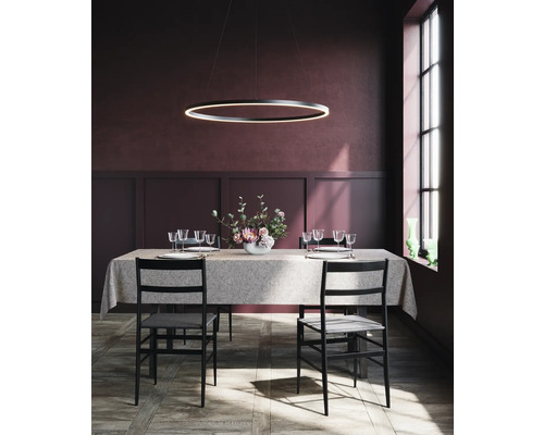 Matbord med bordsplacering under ringformad hängande lampa i en matsal