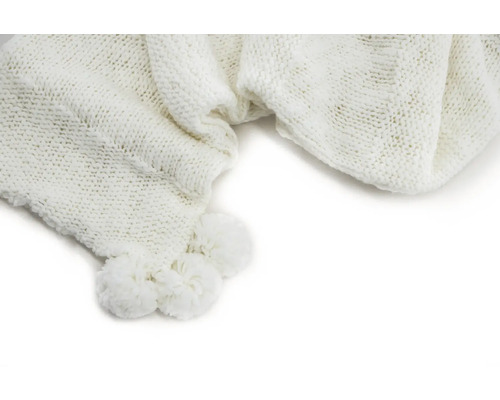 Vit stickad filt med tofsar