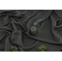 Dekorativt grönt ljus med rökutveckling på mörkt tyg