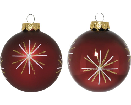 Två julgranskulor med stjärnmönster och upphängningsögla