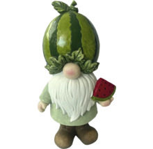 Trädgårdstomte med vattenmelon som huvud och en melon i handen
