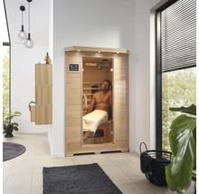 Interiörbild av ett badrum med en Home Deluxe bastu och en man med en handduk
