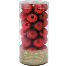 Set röda julgranskulor i glas i transparent förpackning