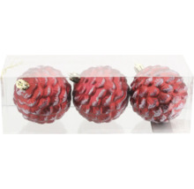 Tre röda julgranskulor i form av en tallkotte i transparent förpackning