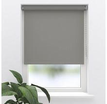 Grå rullgardin vid fönstret