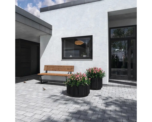 Exteriör av ett modernt hus med bänk, blomlådor och gatstenar