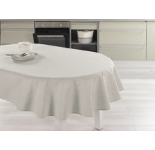 Ett matbord med en duk och porslin i ett ljust kök.