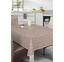 Bord med belagd duk med maskrosmönster i ett ljust kök