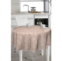 Runt bord med bordsduk med växtmönster i ett kök