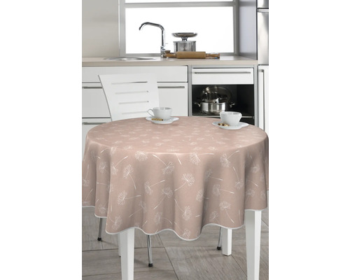 Runt bord med bordsduk med växtmönster i ett kök