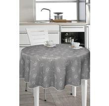 Runt bord med grå duk och maskrosmönster i ett kök.