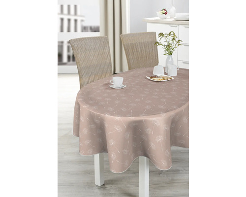 Ovalbord med duk med maskrosmönster, serverat med porslin och bakverk.