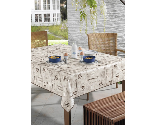 Uteplats med vaxduksduk med kaffemotiv, porslin och frukostingredienser