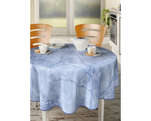 Rund bordsduk med marmormönster på ett matbord