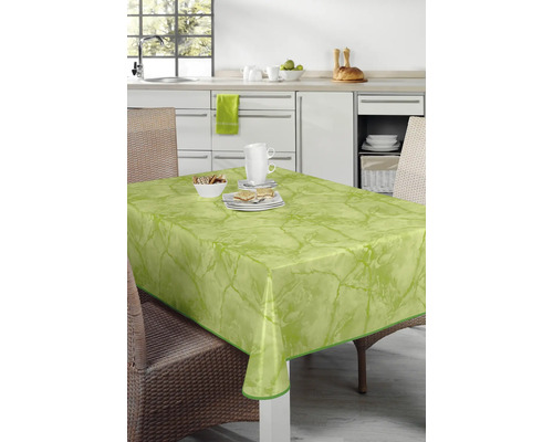 Bordsdekoration med vaxduk och porslin i ljust kök