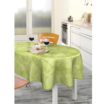 Matbord med ljusgrön vaxduk och porslin i ett ljust kök.