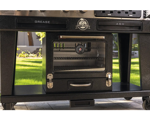 Närbild av grill med fettlåda, asklåda, ugn och temperaturindikator.