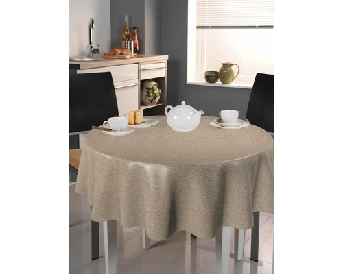 Runt bord med beige duk i ett kök