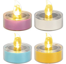 Fyra solcellsdrivna LED-värmeljus i olika färger