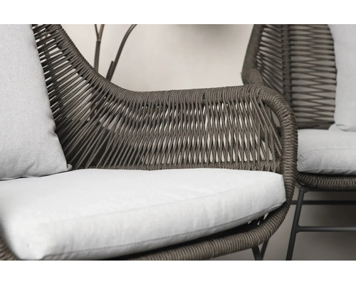 Närbild av en trädgårdsfåtölj med rottingutseende och sittdyna