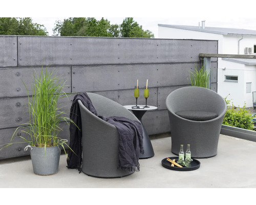 Terrassmiljö med två fåtöljer, sidobord, drycker och dekorativa element