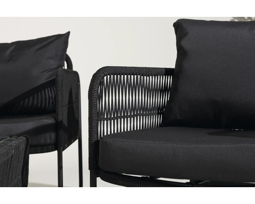 Närbild av två svarta loungestolar med flätade detaljer och kuddar.