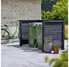 Synskydd för soptunnor med cykel i bakgrunden och blomkrukor i förgrunden
