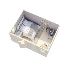 Interiörbild av ett trädgårdshus med säng, bord och stolar