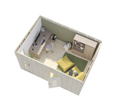 Interiörbild av ett trädgårdshus med skrivbord, stol, förvaringsmöbler och sittdynor