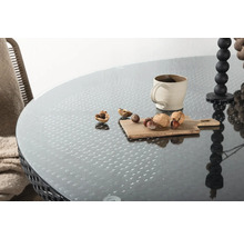 Bord med glasskiva, kopp, ljusstake och nötter på en bräda