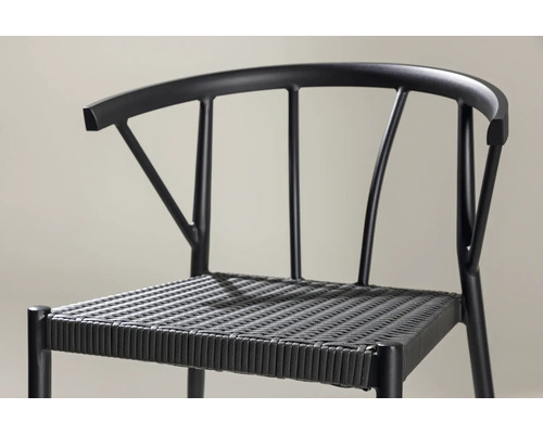 Detaljbild av en svart stol med flätad sits